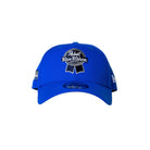 A royal blue baseball cap featuring a prominent embroidered Pabst Blue Ribbon logo on the front, a small New Era flag logo on the side, and a clear visor, set against a solid black background.